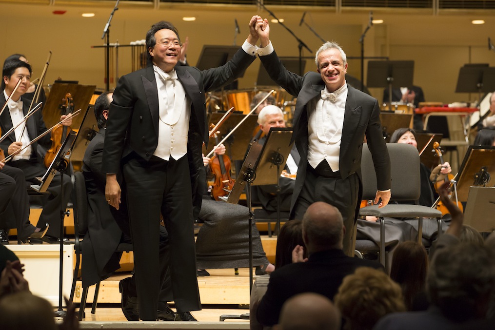 Yo-Yo Ma and Giovanni Sollima share applause after the world premiere of Sollima's "Antidotum Tarantulae XXI" with Riccardo Muti and the CSO Thursday night. Photo: Todd Rosenberg