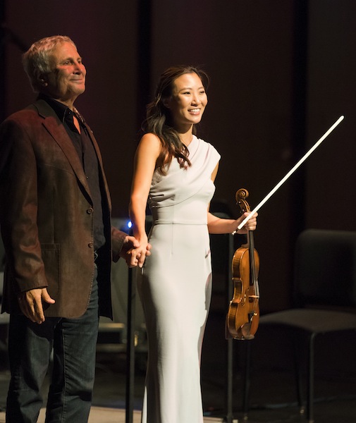 CSO associate concertmaster Stephanie Jeong takes a bow with composer John Corigliano following her performance of his "Red Violin Caprices" at MusicNOW's 20th anniversary concert Monday night at the Harris Theater. Photo: Todd Rosenberg